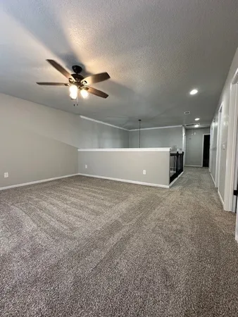 a view of a ceiling fan and window