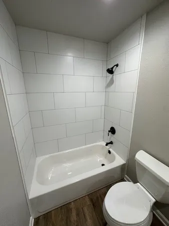 a white bath tub sitting next to a white toilet