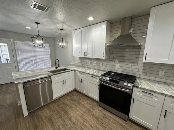 a kitchen with a sink stove and cabinets