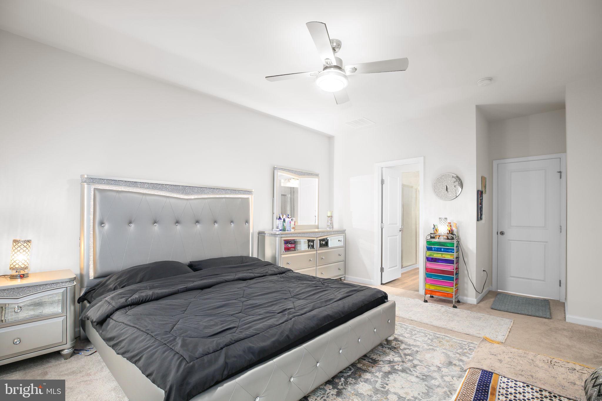 18353 Reaper Hl Court Triangle, VA 22172 - Photo 14 of 29 Ceiling fan and carpet in the primary bedroom