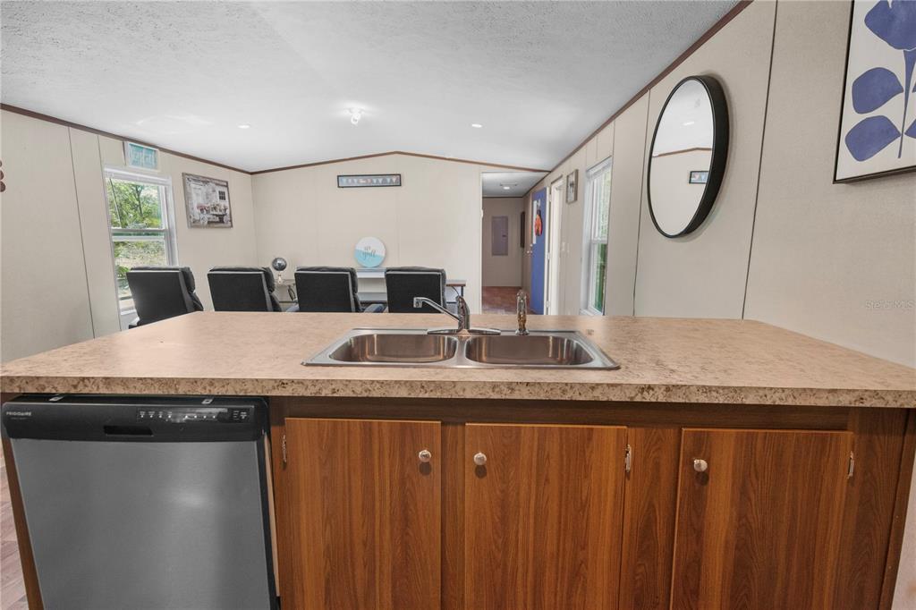 16770 Southwest 60th Place Ocala, FL 34481 - Photo 13 of 26 a kitchen with a granite countertop sink and a mirror