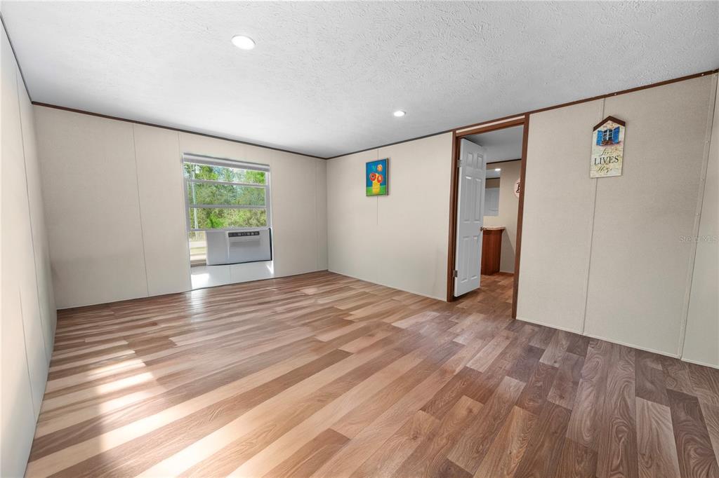16770 Southwest 60th Place Ocala, FL 34481 - Photo 17 of 26 a view of an empty room with window and wooden floor