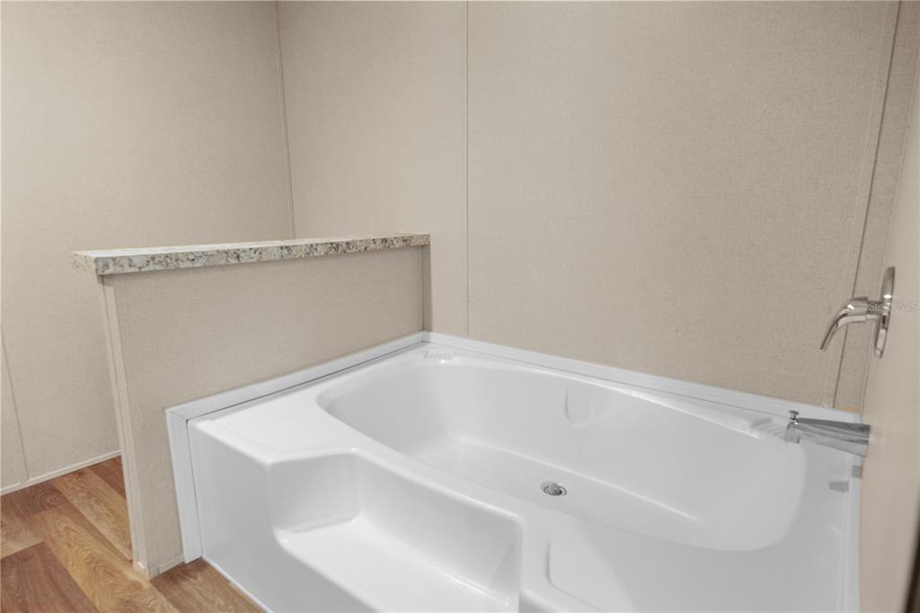 16770 Southwest 60th Place Ocala, FL 34481 - Photo 19 of 26 a white bath tub sitting in a bathroom