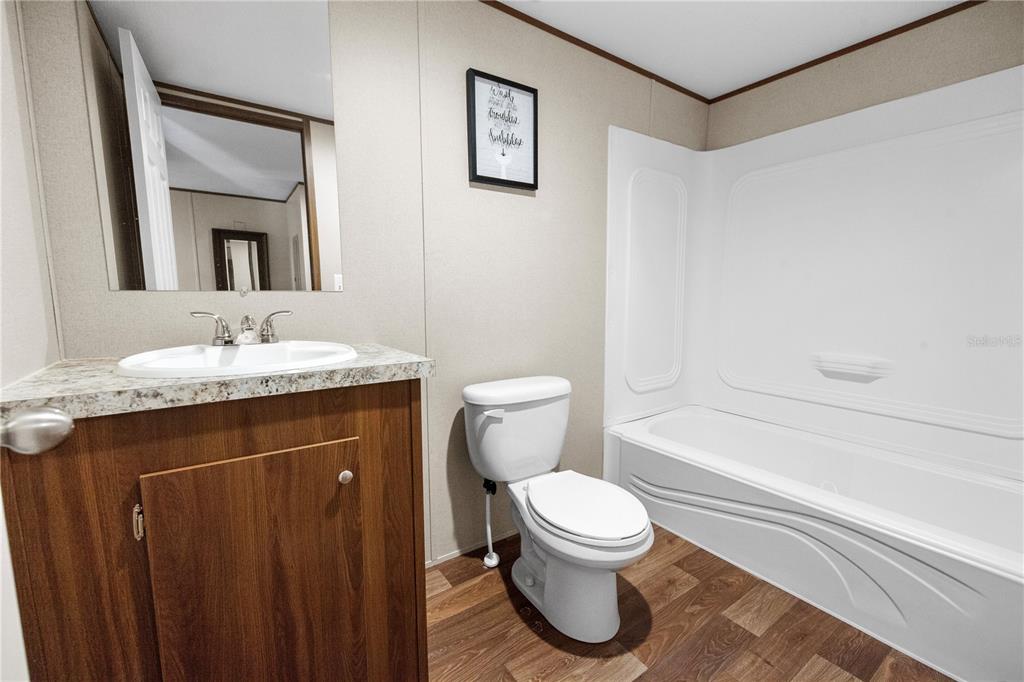 16770 Southwest 60th Place Ocala, FL 34481 - Photo 26 of 26 a bathroom with a granite countertop sink toilet and shower