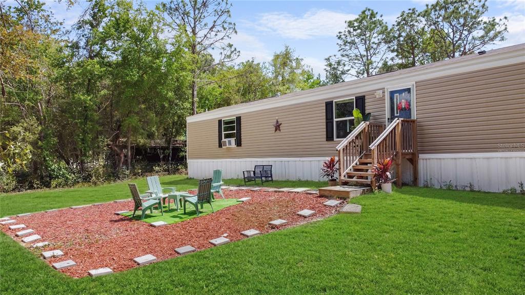 16770 Southwest 60th Place Ocala, FL 34481 - Photo 5 of 26 a view of a backyard with plants and a backyard