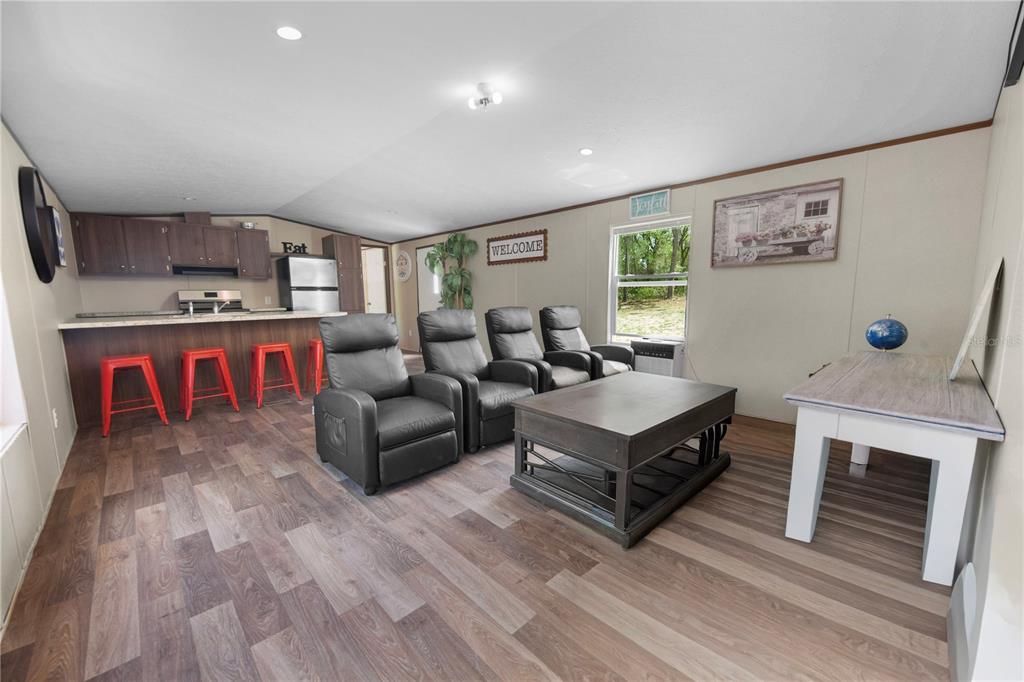 16770 Southwest 60th Place Ocala, FL 34481 - Photo 7 of 26 a living room with furniture a flat screen tv and a fireplace