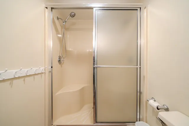 a spacious bedroom with two beds and a chandelier