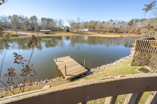 a wooden bench sitting next to a lake