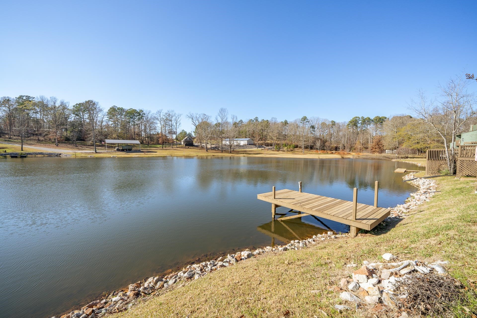 116 Driftwood Road Counce, TN 38326 - Photo 28 of 31 a wooden bench sitting next to a lake