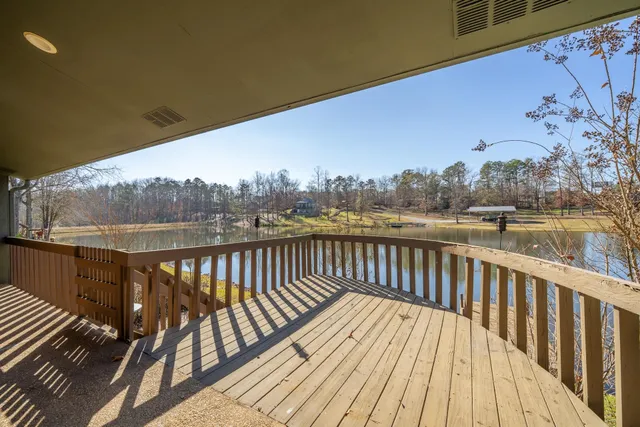 a view of balcony with wooden floor and fence