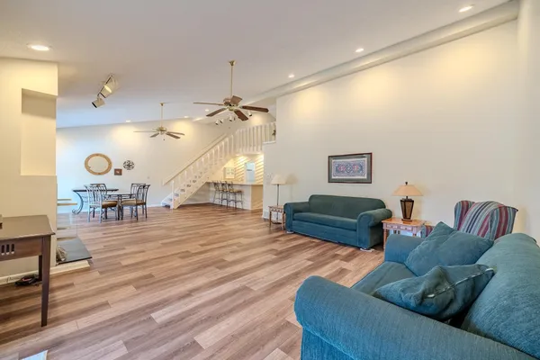 a living room with furniture and wooden floor