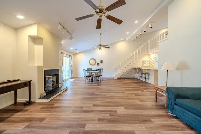 a living room with fireplace furniture and a wooden floor