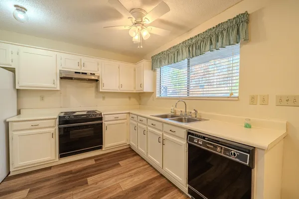 a kitchen with stainless steel appliances a stove a sink and a microwave