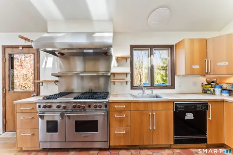 a stove top oven sitting inside of a kitchen