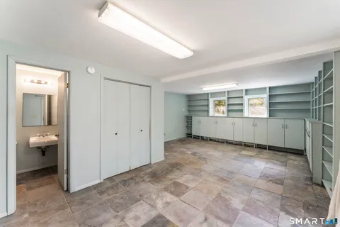 a view of an empty room with bathroom and a window