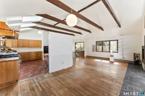 a view of a livingroom with wooden floor and stairs
