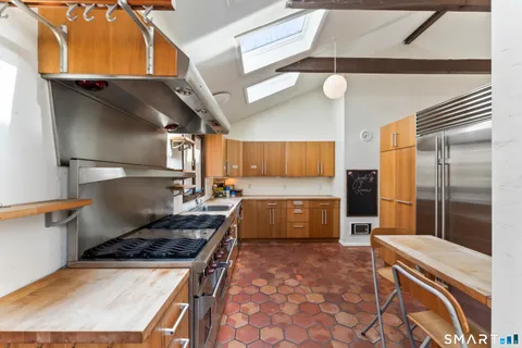 a kitchen with a stove a sink and a refrigerator