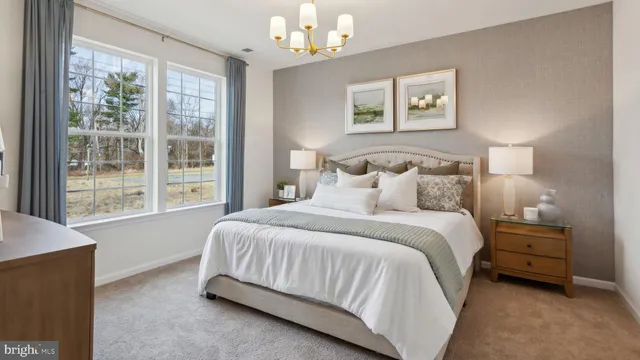 a bedroom with a bed chandelier and a window