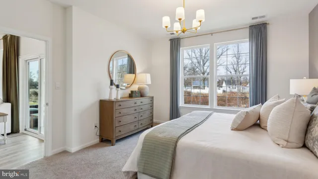 a bedroom with a bed wooden floor and a window