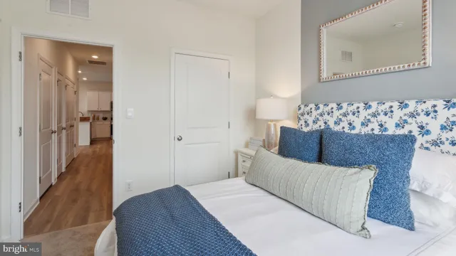 a bedroom with a bed and a mirror