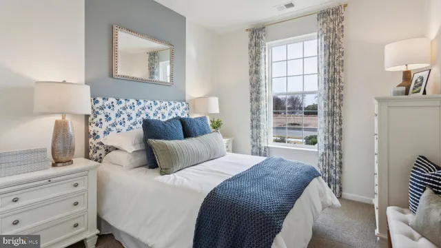 a bedroom with a bed and lamp