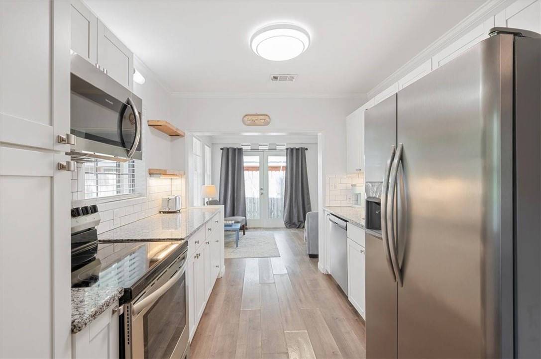 238 Broadway Street St. Simons Island, GA 31522 - Photo 10 of 56 The pass through kitchen leads to the cozy living room.
