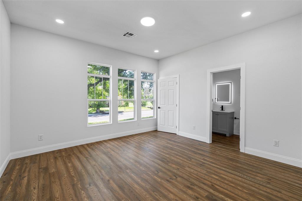 2023 Bosque Boulevard Waco, TX 76707 - Photo 4 of 26 Spacious room featuring wood-finish flooring, recessed lighting, and three tall windows