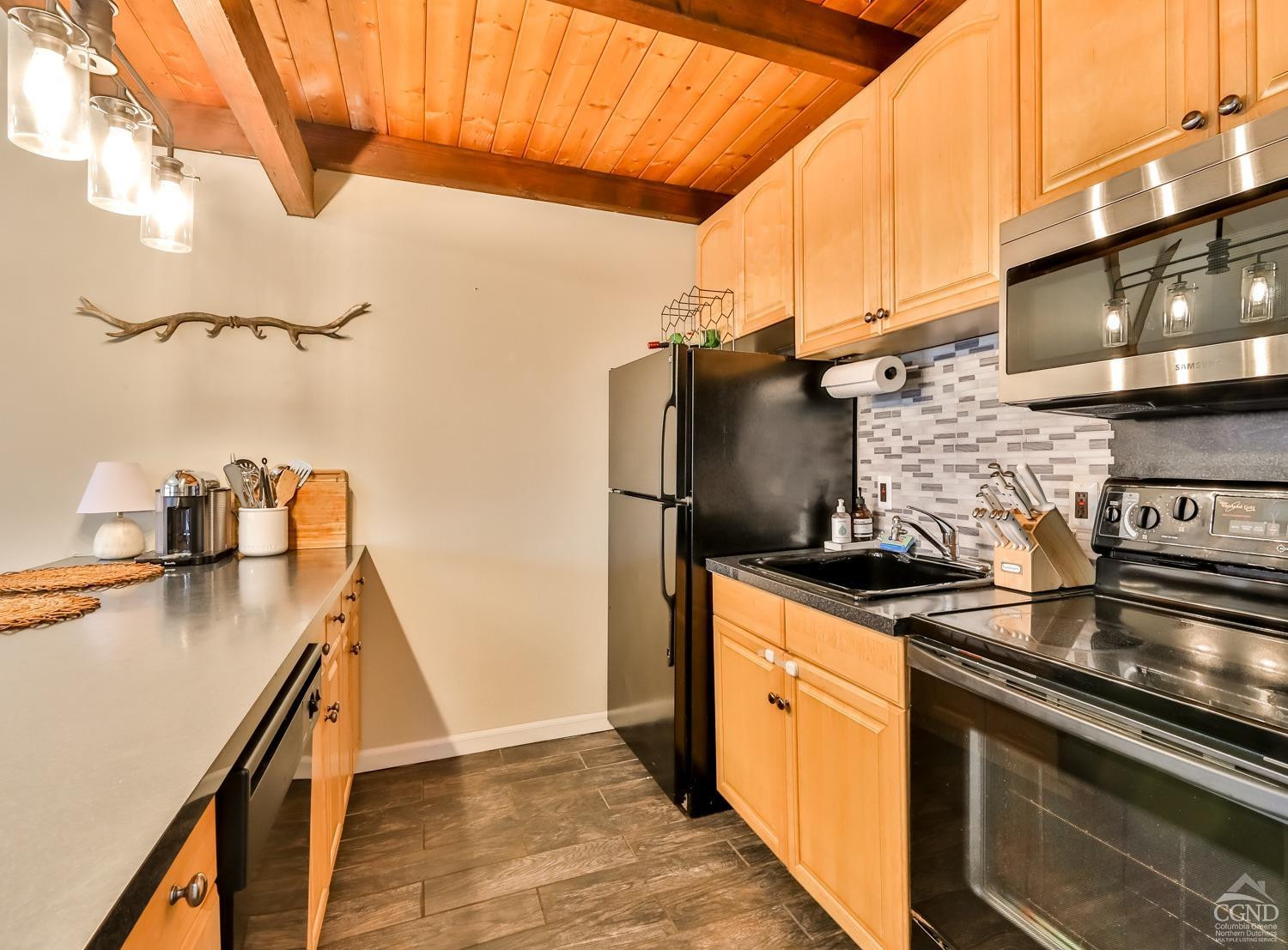 110-2 Highridge Road Windham, NY 12439 - Photo 22 of 48 a kitchen with stainless steel appliances granite countertop a sink a stove and a refrigerator