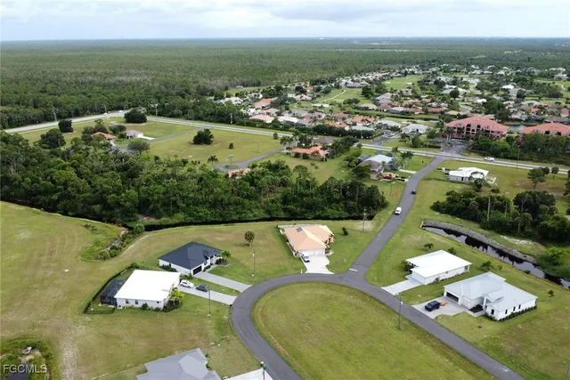 an aerial view of a house with a swimming pool yard and outdoor seating