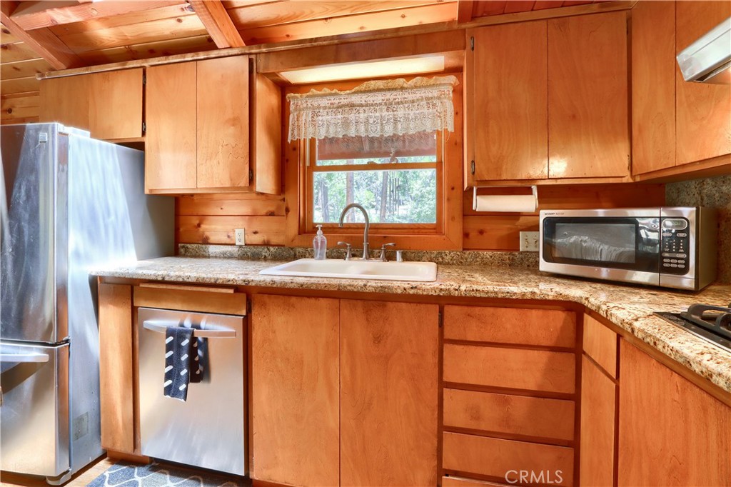 7190 Hites Cove Road Mariposa, CA 95338 - Photo 14 of 61 a kitchen with stainless steel appliances granite countertop a stove a sink and a microwave