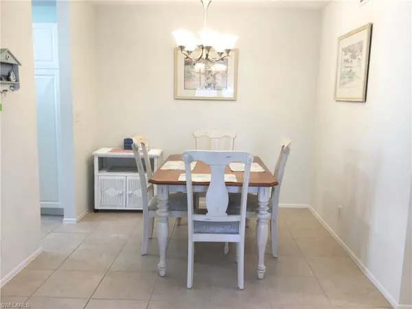a dining room with furniture and a window