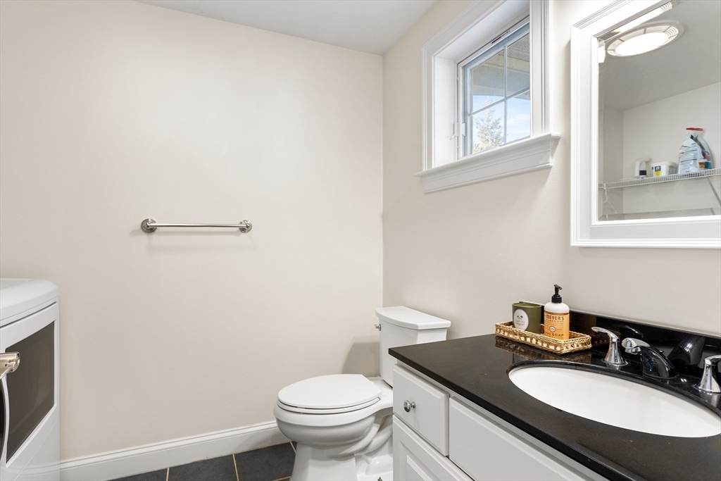 3 Fieldstone Circle, Unit 3 Wareham, MA 02576 - Photo 12 of 25 a bathroom with a granite countertop sink toilet and a mirror