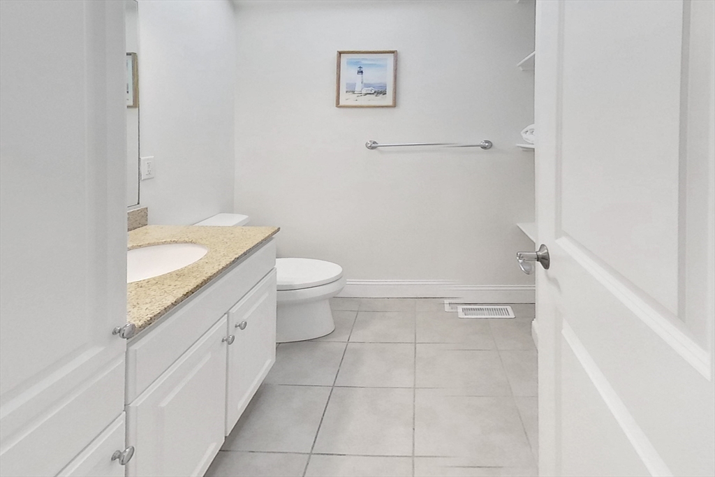 3 Fieldstone Circle, Unit 3 Wareham, MA 02576 - Photo 16 of 25 a bathroom with a granite countertop sink a toilet and a mirror