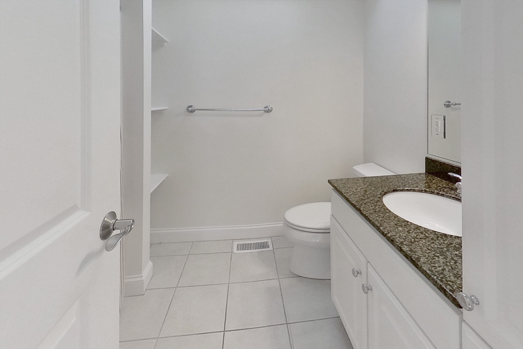 3 Fieldstone Circle, Unit 3 Wareham, MA 02576 - Photo 19 of 25 a bathroom with a granite countertop sink a toilet and shower