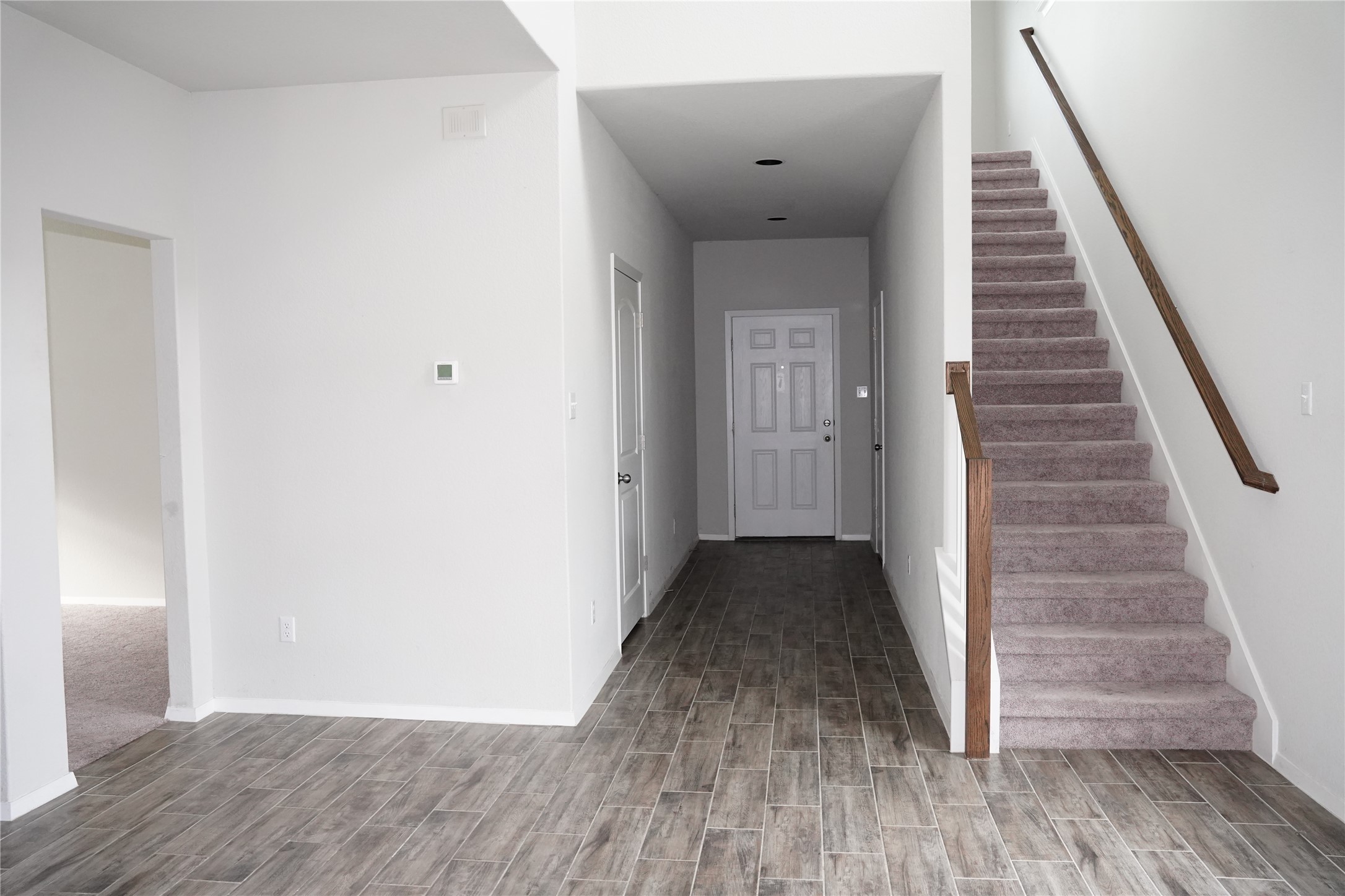 117 Crescent Street Georgetown, TX 78626 - Photo 34 of 38 A welcoming entryway boasts resilient tile flooring and a carpeted staircase leading to upper levels.