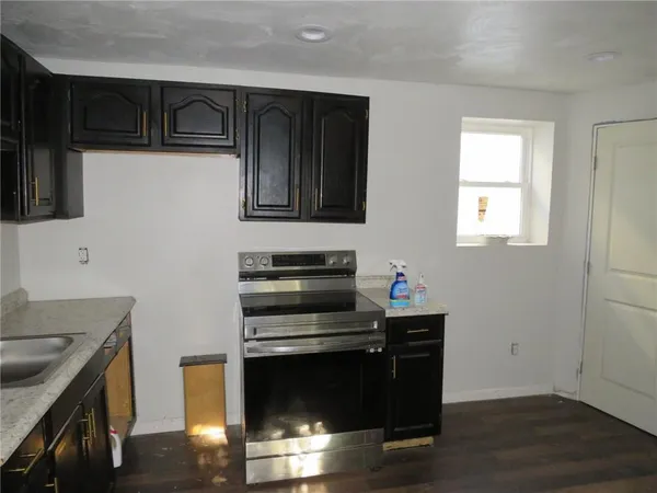 a kitchen with a sink and a stove top oven