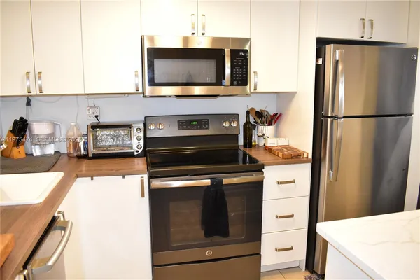a kitchen with a refrigerator stove and microwave