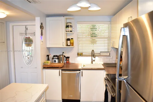 a kitchen with refrigerator and window