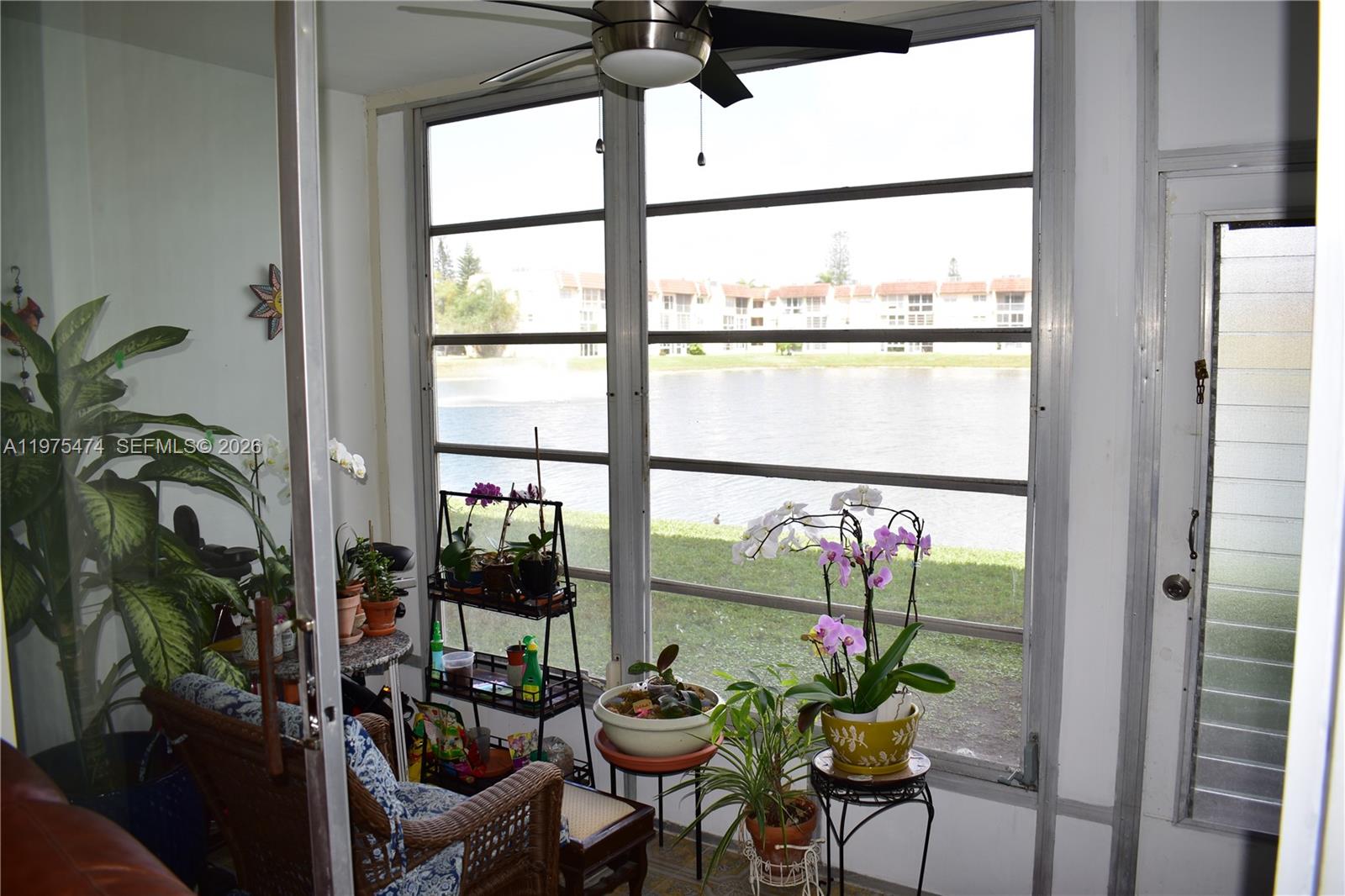 2801 North Pine Island Road, Unit 112 Sunrise, FL 33322 - Photo 19 of 49 a view of a workspace with furniture and floor to ceiling window