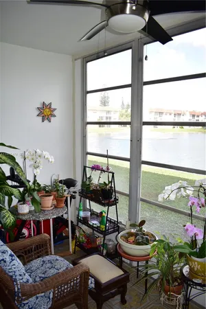 a living room with furniture and flowers