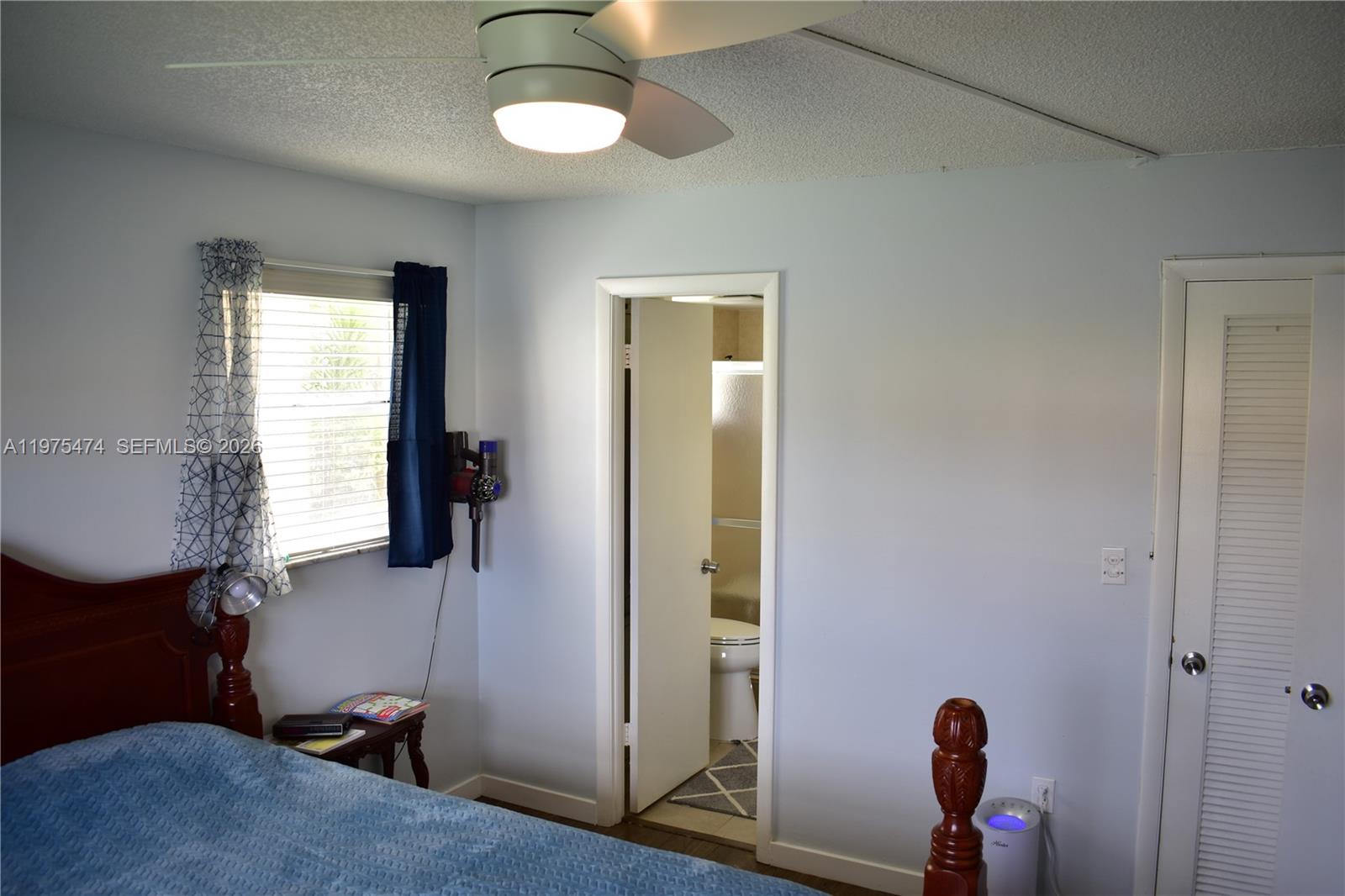 2801 North Pine Island Road, Unit 112 Sunrise, FL 33322 - Photo 22 of 49 a room that has a bed and a window