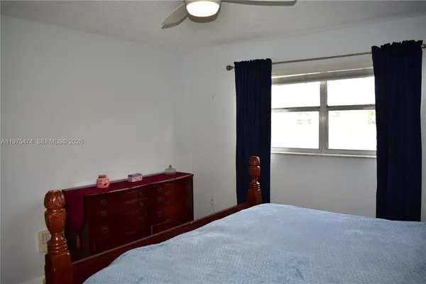 a room with a dresser and a window