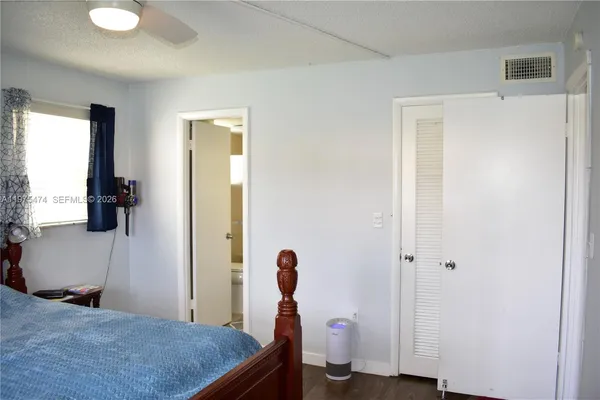 a bedroom with a bed and a flat tv screen