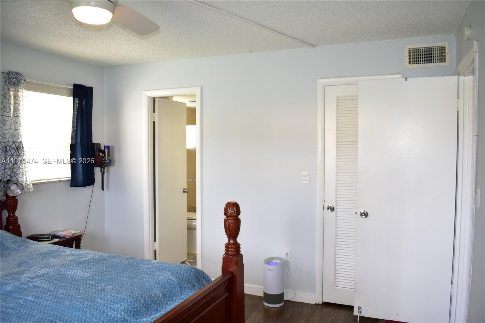 2801 North Pine Island Road, Unit 112 Sunrise, FL 33322 - Photo 26 of 49 a bedroom with a bed and a flat tv screen