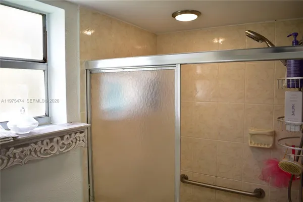 a bathroom with a shower and a sink