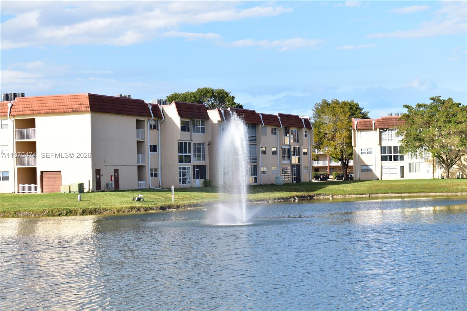 2801 North Pine Island Road, Unit 112 Sunrise, FL 33322 - Photo 3 of 49 a view of an swimming pool with an outdoor space and seating area