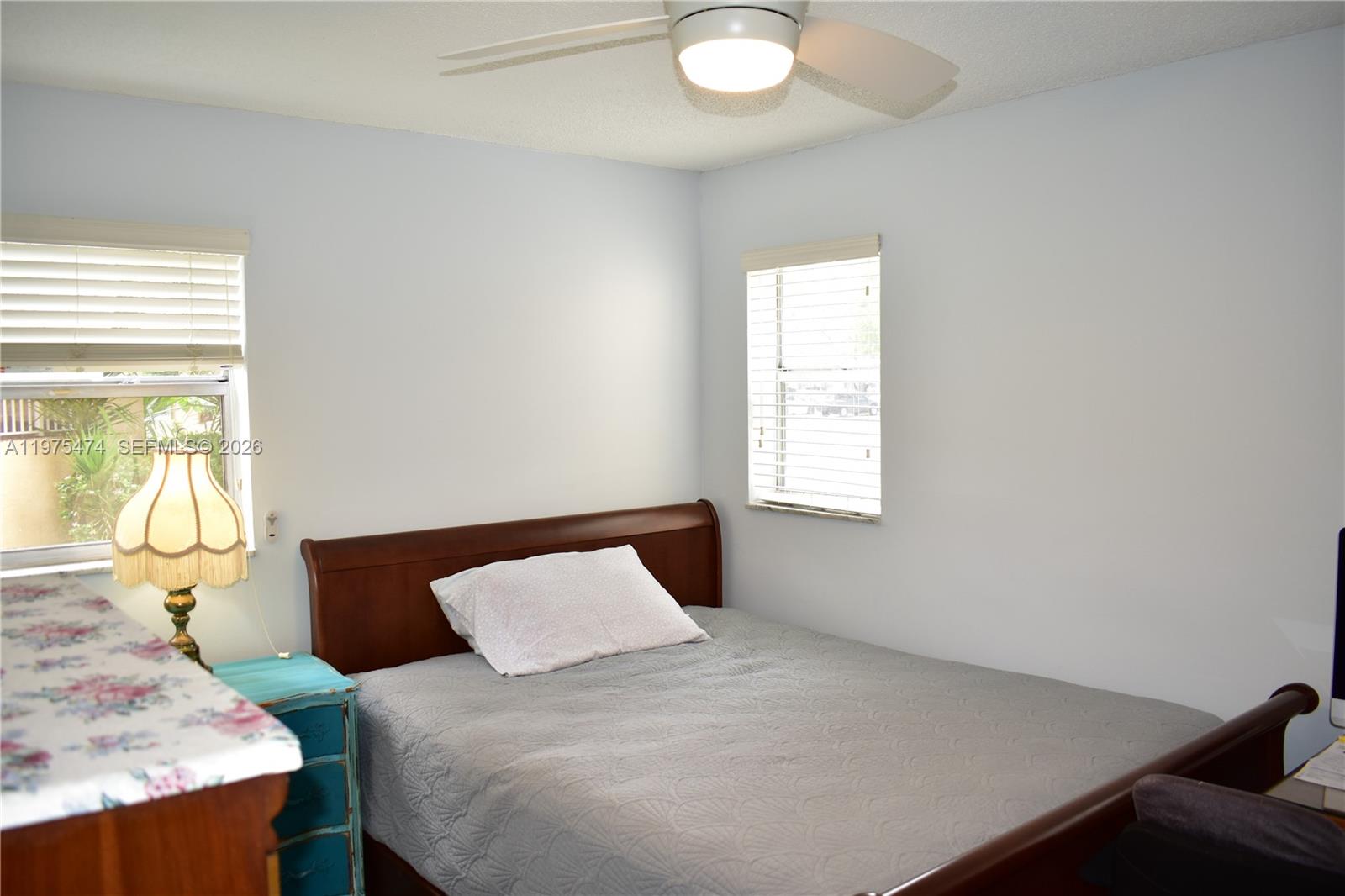 2801 North Pine Island Road, Unit 112 Sunrise, FL 33322 - Photo 34 of 49 a bedroom with a bed and wooden floor