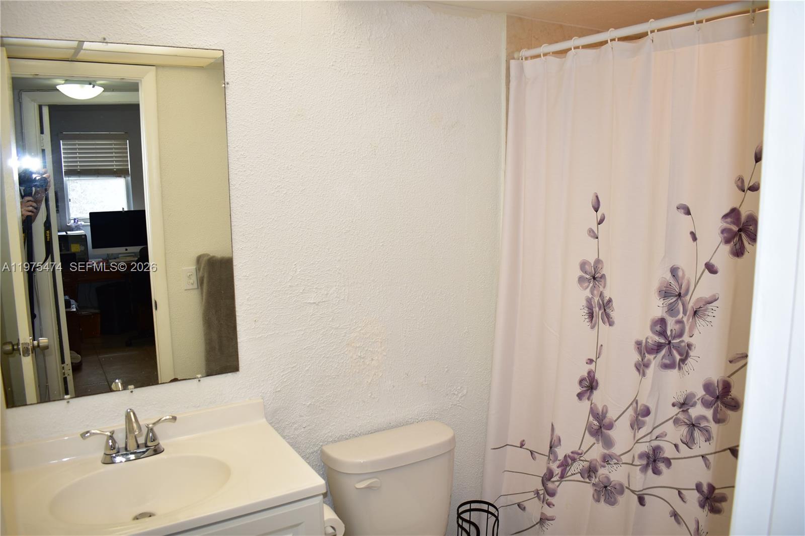 2801 North Pine Island Road, Unit 112 Sunrise, FL 33322 - Photo 36 of 49 a bathroom with a sink and a mirror