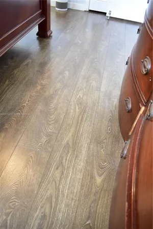 a view of a room with wooden floor