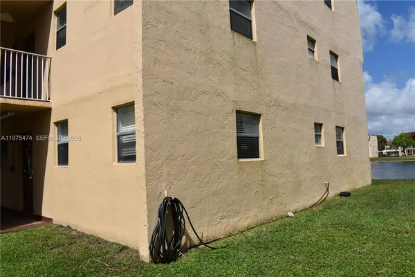 a view of backyard with barbeque grill and plants